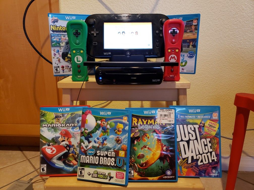 Nintendo Wii U console with two controllers and 6 games