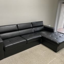 Black “leather” L-shaped Couch