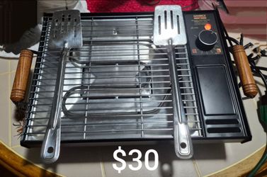 Vintage cooking grill with cooking utensils