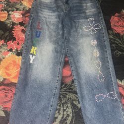 High-waisted, straight-leg blue jeans with rhinestone