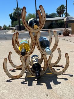 Large Horseshoe wine holder / trailer hitch decoration made from welded horse shoes vintage western