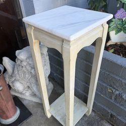 White marble column plant stand