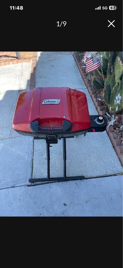 Portable red Coleman RoadTrip Sportster Propane Gas Grill.