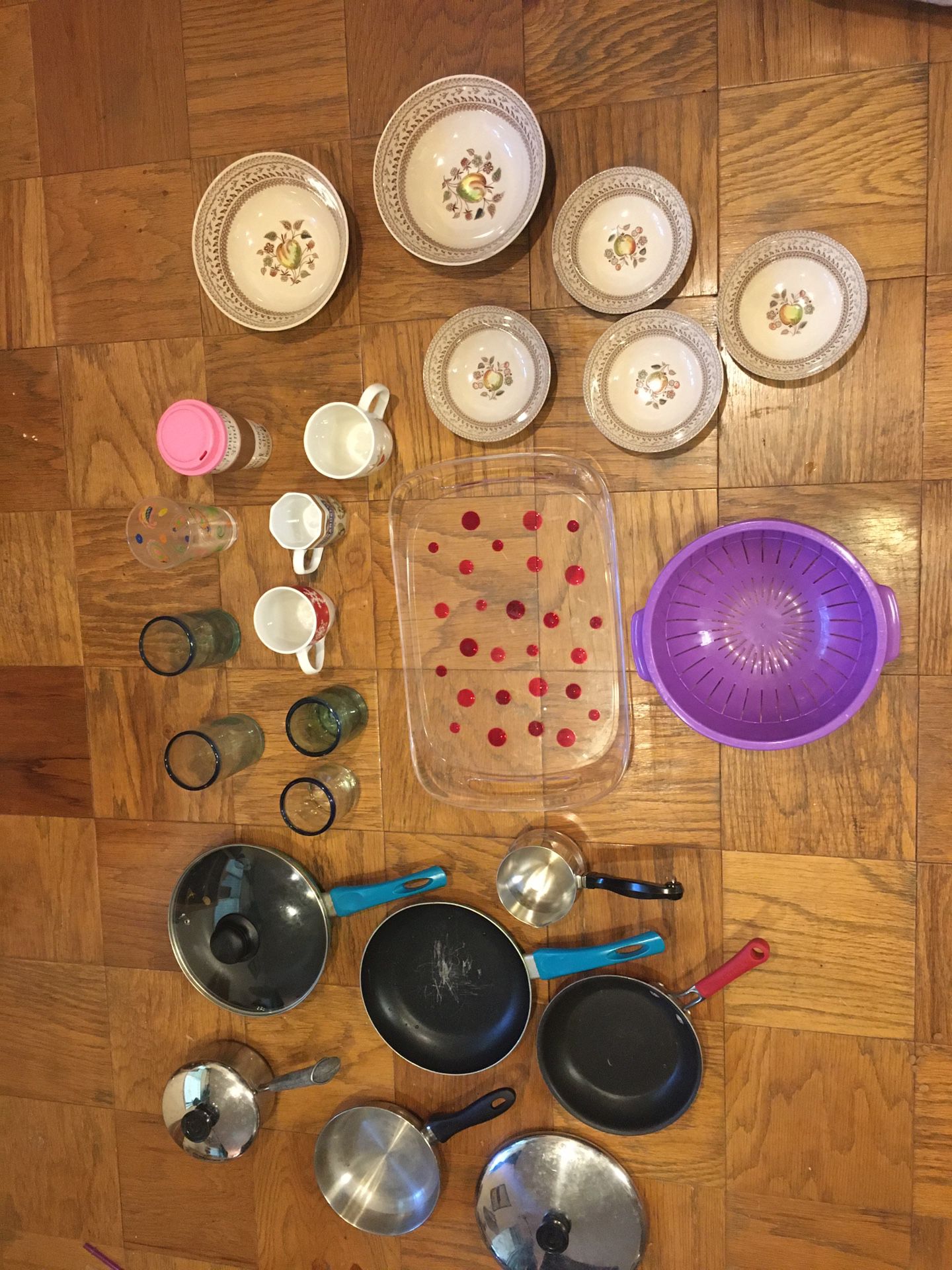 Various kitchen items: pots, pans, glasses, mugs, serving tray, strainer