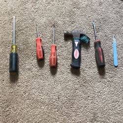 Small Tool Kit With Four Screwdrivers, One Hammer And One Small Little Knife