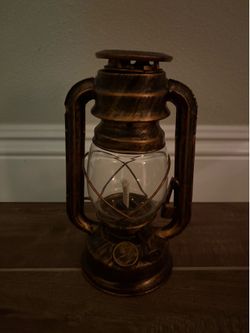 vintage-style bronze lantern serves as a rustic decorative piece