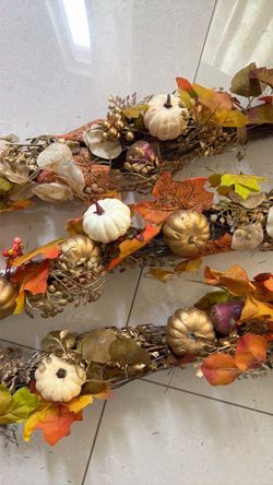 artificial fall twig/stick garlands decorated with pumpkins, berries, and autumn foliage.$35