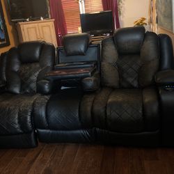 Recliner galdiator Black sofa W Charger And cup Holders In The Seats And In Middle The Sofa