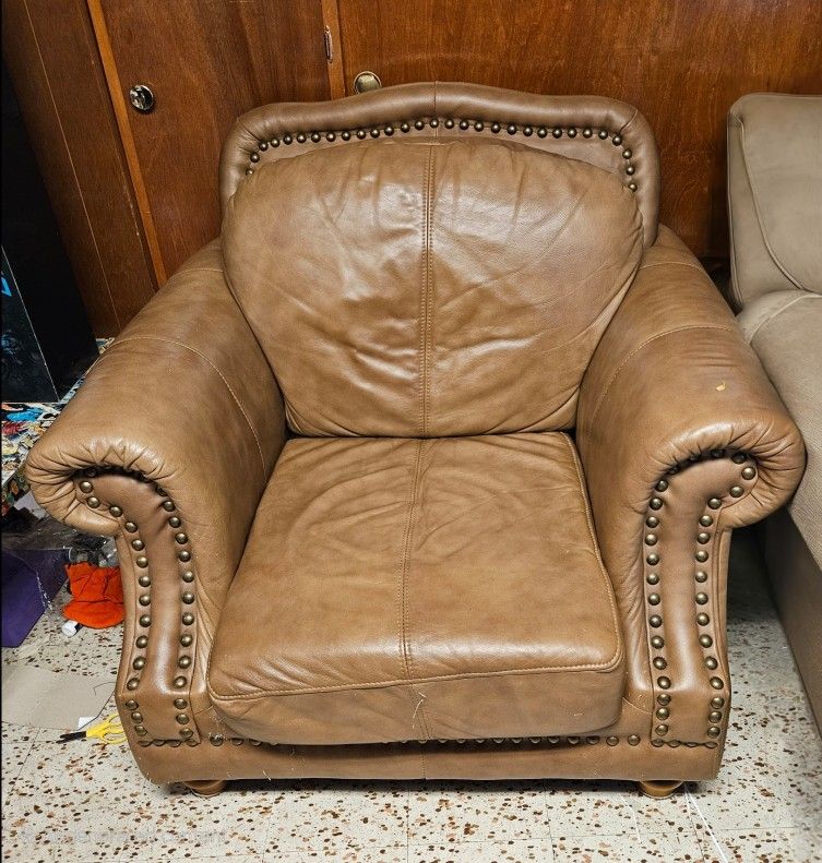 For sale is a stylish and comfortable brown leather armchair