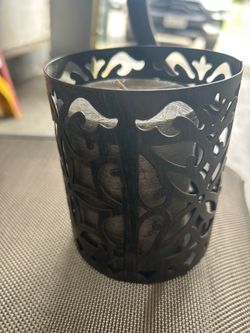 Black metal candle holder with gray unscented candle