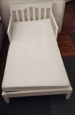 White Ikea Toddler Bed and Mattress. Comes with mattress protector and bed sheets