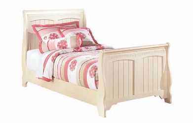Twin bed with box spring, mattress, comforter and nightstand.