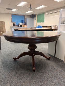 Round dark wood table with additional leaf