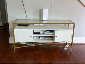 Gold and white console table with two drawers.