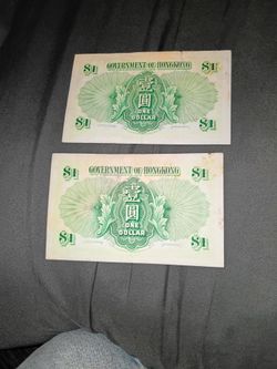 Two two $1 Hong Kong banknotes Queen Elizabeth on them.