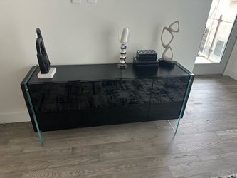 modern black lacquer sideboard / credenza with architectural tempered-glass legs.