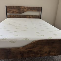 Queen-size bed frame with headboard and footboard, plus mattress included