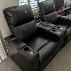 Two Black Faux Leather Power Recliner Chairs With Rotating Table, USB Outlets, And Cup Holders