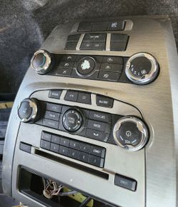 Radio and climate control panel for a 2010-2012 Ford Fusion. 