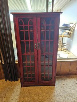 Media cabinet in cherry finish with glass doors