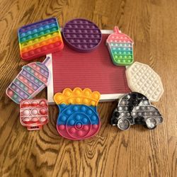 Sensory Fidget Bubble Toys And 10 X 10 Letter Board Sign White Frame Pink Background