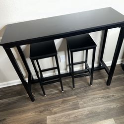 Black kitchen bar table with bar stools