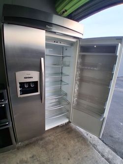 This 48-inch wide refrigerator is in good condition and comes with a 5-month warranty. It's a Thermador brand and has an ice maker and water dispenser