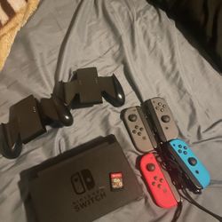 NINTENDO SWITCH . TWO REMOTES 1 GAME 2 CONFORM GRIPS. MISSING POWER CORD