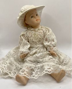 A vintage porcelain or bisque collectible doll