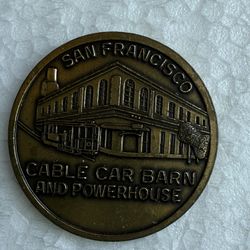 Bronze souvenir coin featuring the San Francisco Cable Car Barn and Powerhouse. 