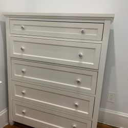 white 5-drawer chest of drawers featuring decorative floral knobs
