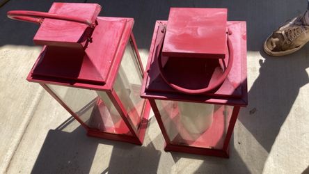 pair of pinkish-red metal and glass candle lanterns