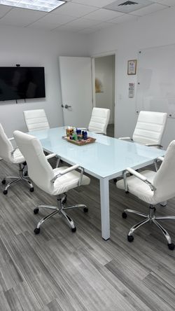 Modern glass conference room table with 6 chairs
