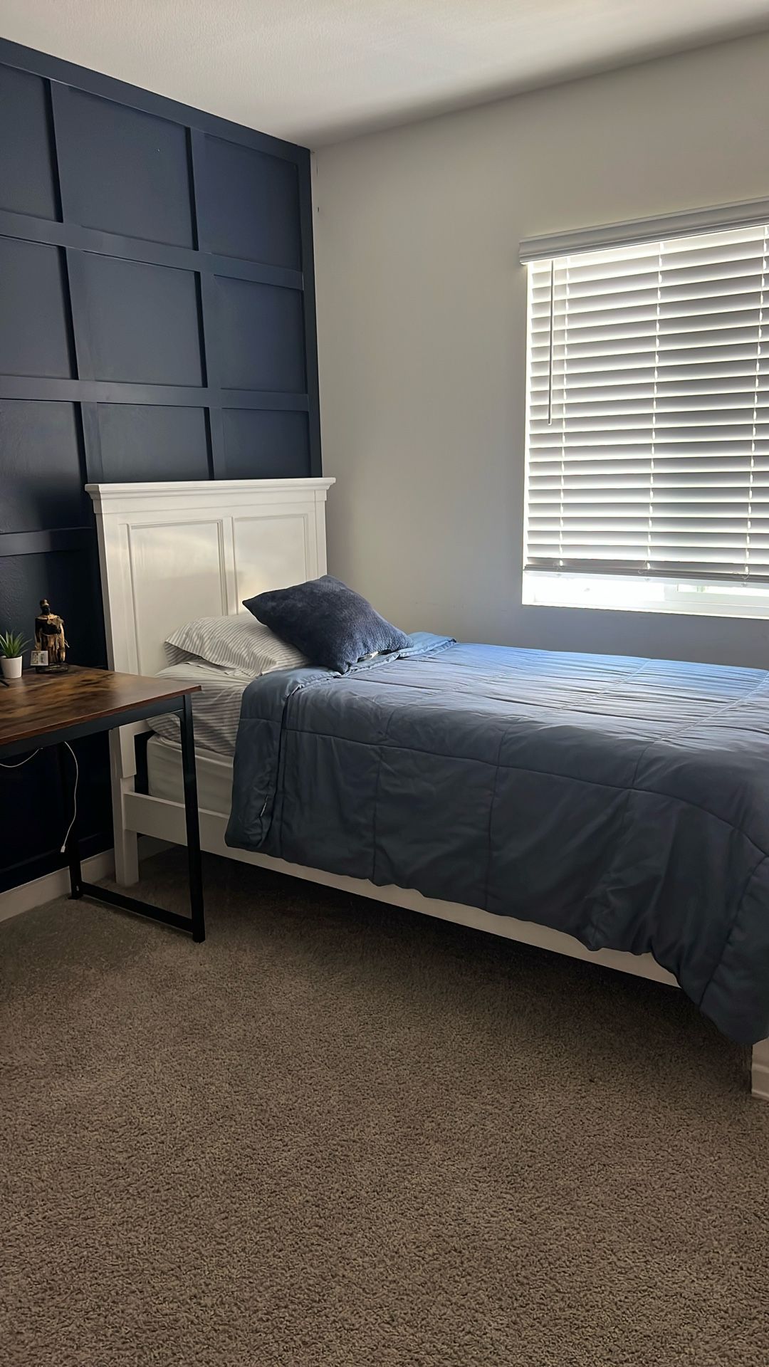 White twin bed with mattress and boxspring and nightstand