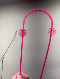 Two pink trellises  with flowers