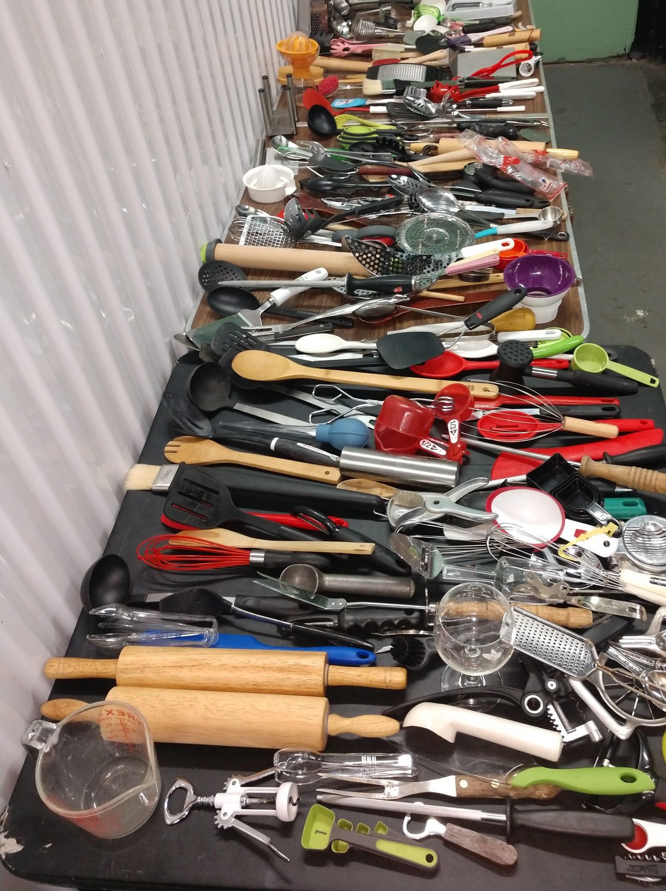 Lots of kitchen utensils forks spoons knives spatulas measuring cup cheese grater cutters