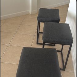 Selling a set of 3 modern bar stools with black metal frame and cushioned seats. Clean, simple design that fits great in kitchens, islands, or apartme