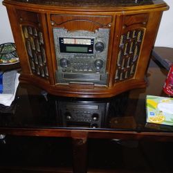 Old fashioned radio with cassette record player c d player records