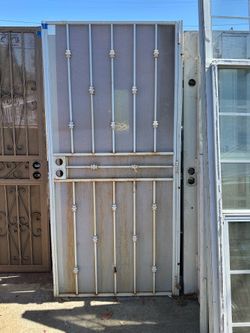 Durable wrought iron security screen door is white with a perforated metal screen. It has a height of 80 inches and a width of 36 inches. The door inc