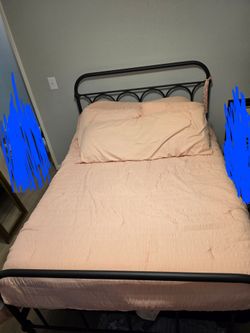 Full size  metal bed frame with mattresses.