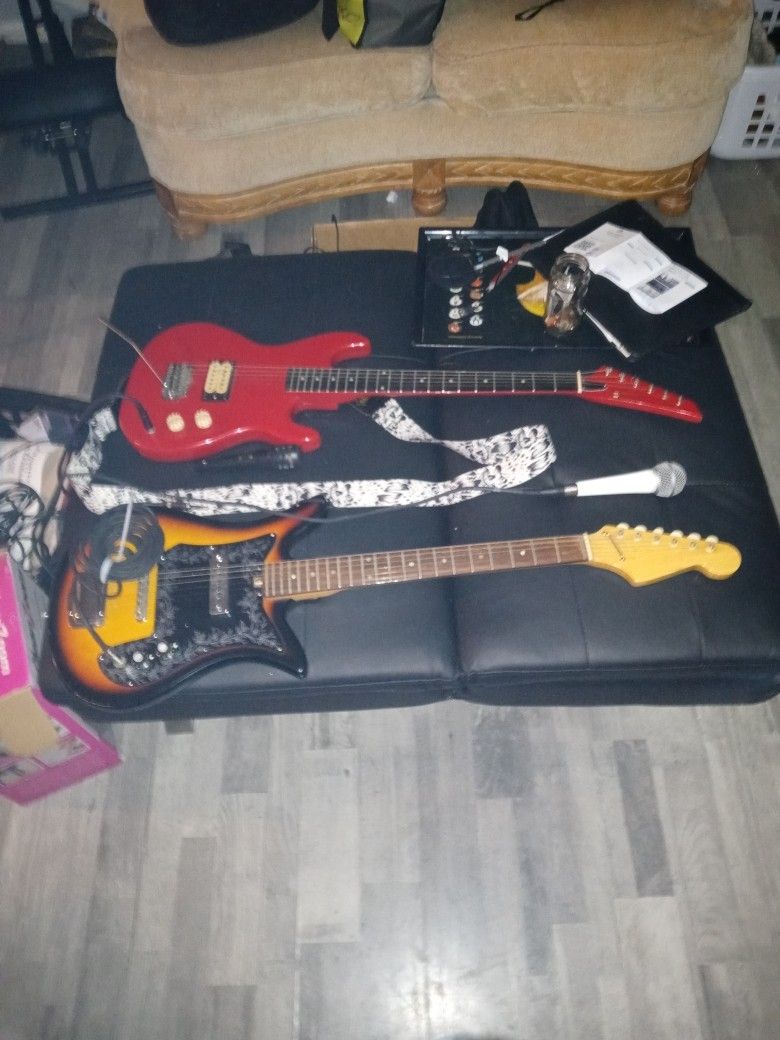 Two. Guitars 2 Mics Two Plugs For Guitats For Amp Wires For Microphones As Well Cruise Guitar And One 1968 Vintage Guitar One Shure Mic One Dynamic M