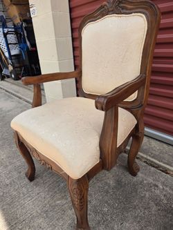 Upholstered chair with ornate wood