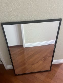 Mirror in a black metal frame.