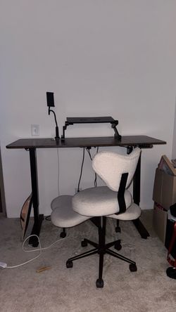 Electric Standing Desk with Dark Wood Top and ergonomic chair