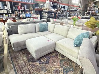 Grey fabric sectional with ottoman from Costco