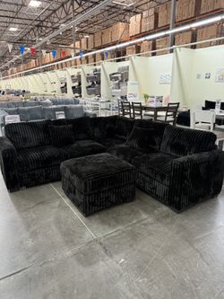 BRAND NEW BLACK FLUFFY CORDUROY SECTIONAL WI OTTOMAN