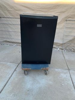 Small black refrigerator in good condition for sale