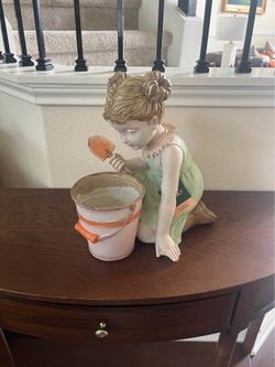Decorative girl figurine holding a planter - perfect garden ornament