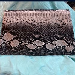 Faux python print clutch with skinny chain to carry. 