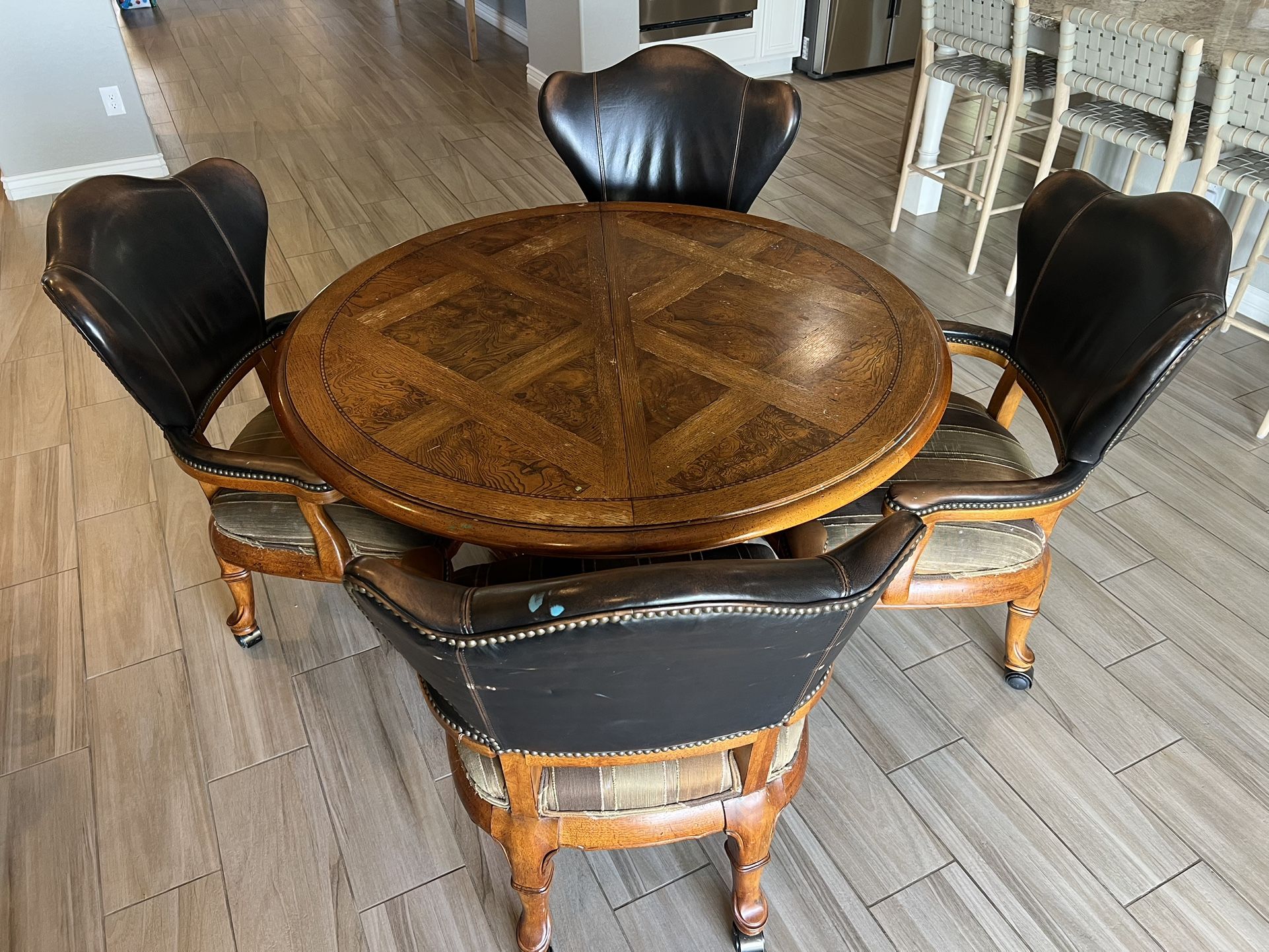 Ornate Heavy Table with Four Rolling Chairs